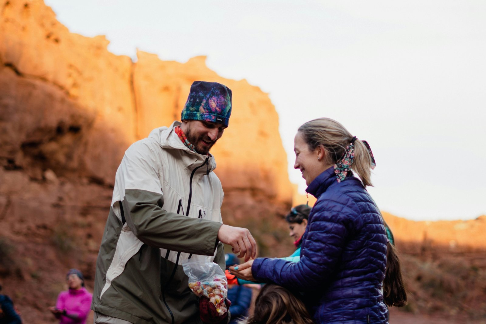 Assortment of healthy travel snacks including nuts, fresh fruit, and energy bars, neatly packed in reusable containers, ready for a sustainable and energized journey.