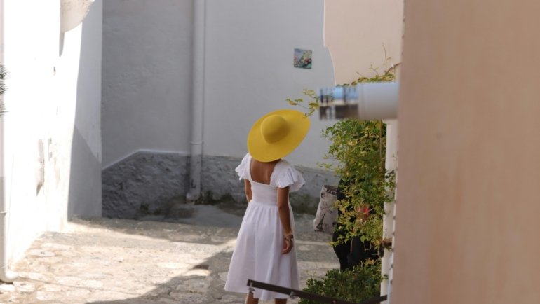 Stylish woman wearing a comfortable and versatile travel dress exploring a European city, perfect for light packing and effortless vacation outfits.