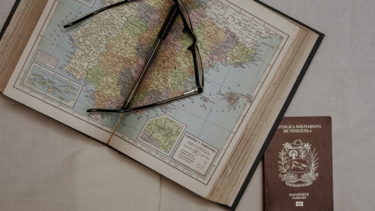 Passport, travel documents, and a map of Spain, clarifying visa requirements and Schengen Zone entry for confident travel.