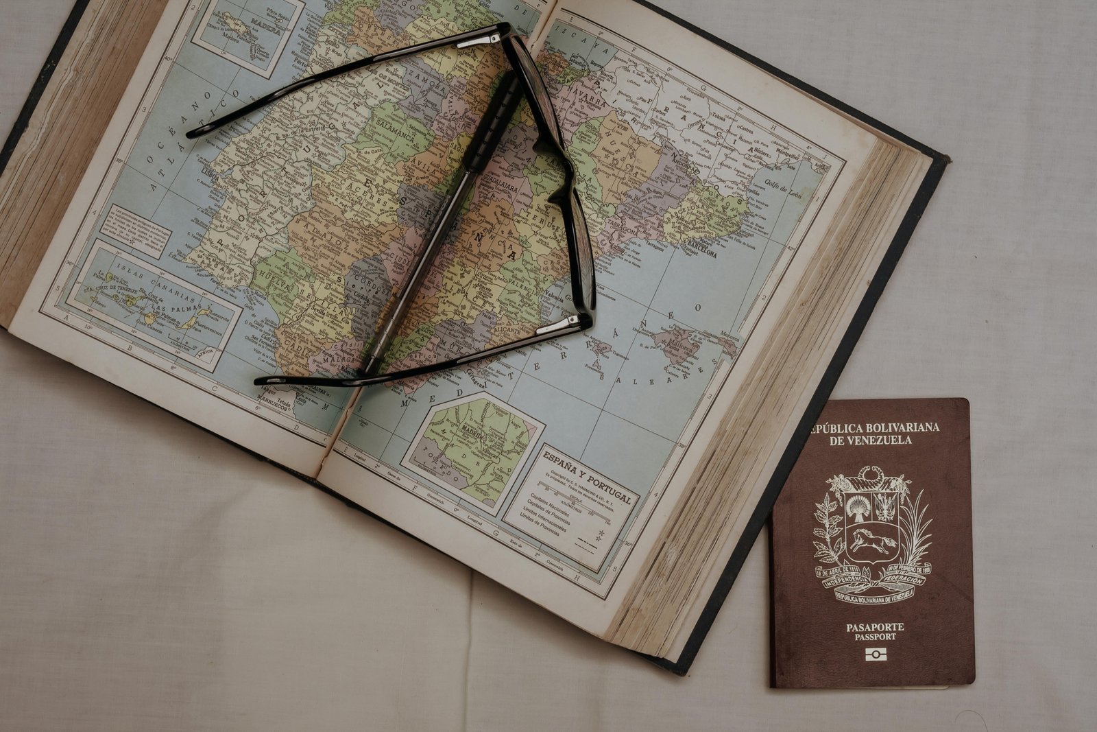 Passport, travel documents, and a map of Spain, clarifying visa requirements and Schengen Zone entry for confident travel.