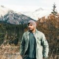 Traveler wearing a modern, functional travel jacket in an urban or natural setting, emphasizing its versatility, secure pockets, and lightweight design for convenient and secure adventures.