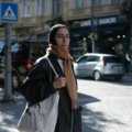 A stylish traveler wearing a secure cross body travel bag while exploring a bustling city street, showcasing hands-free convenience and peace of mind for urban adventures.