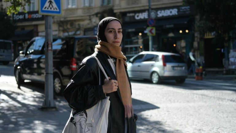 A stylish traveler wearing a secure cross body travel bag while exploring a bustling city street, showcasing hands-free convenience and peace of mind for urban adventures.