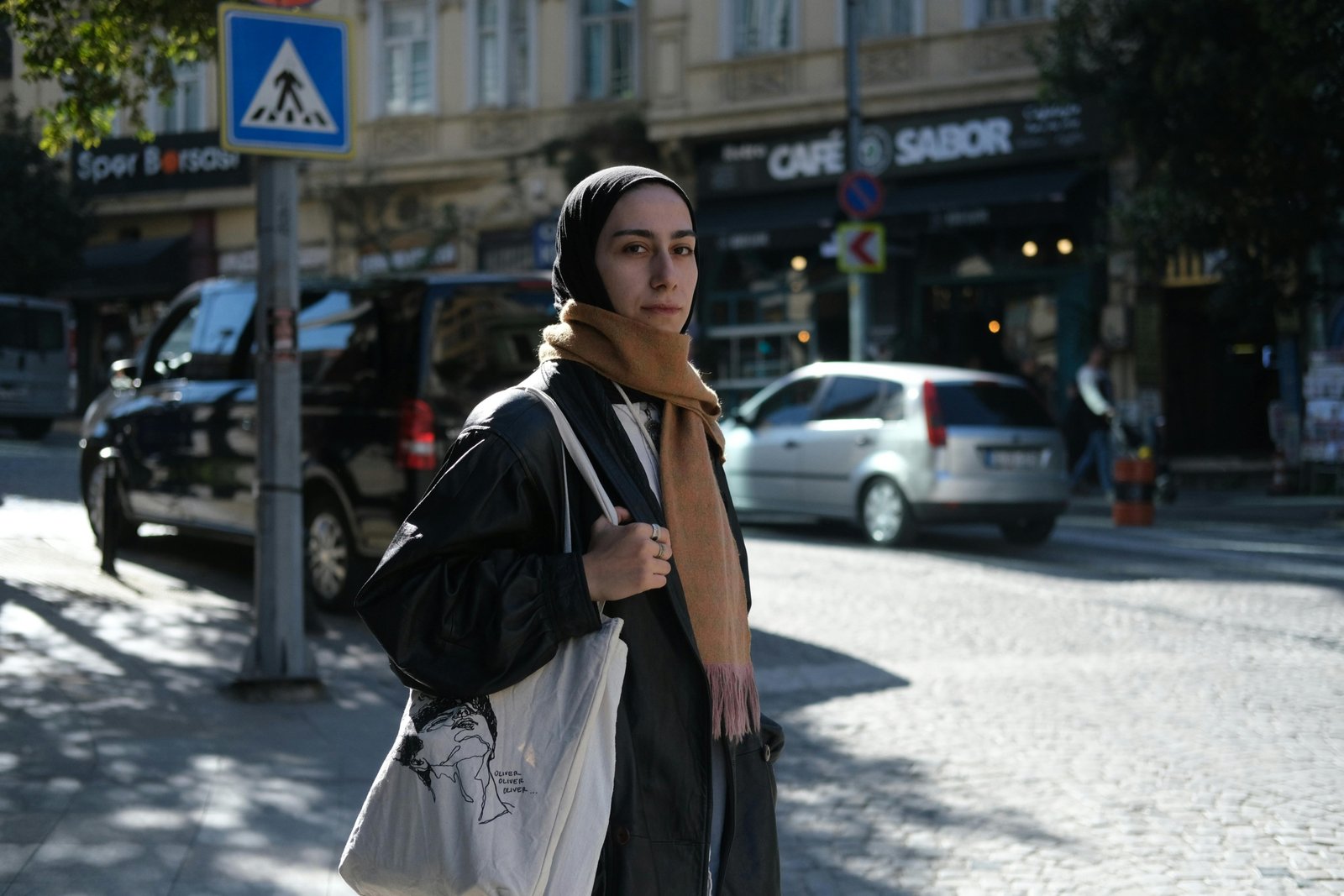 A stylish traveler wearing a secure cross body travel bag while exploring a bustling city street, showcasing hands-free convenience and peace of mind for urban adventures.