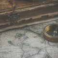 A close-up of a beautifully bound vintage edition of 'The Travels of Marco Polo' resting on an antique map, symbolizing the thrilling online quest for rare and collectible books on AbeBooks.