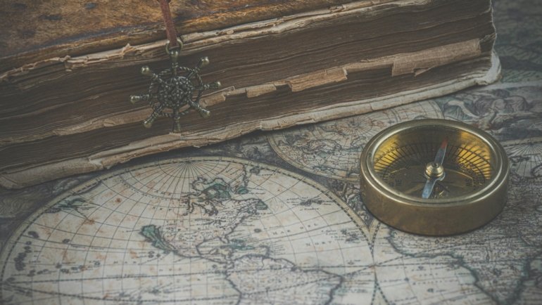 A close-up of a beautifully bound vintage edition of 'The Travels of Marco Polo' resting on an antique map, symbolizing the thrilling online quest for rare and collectible books on AbeBooks.