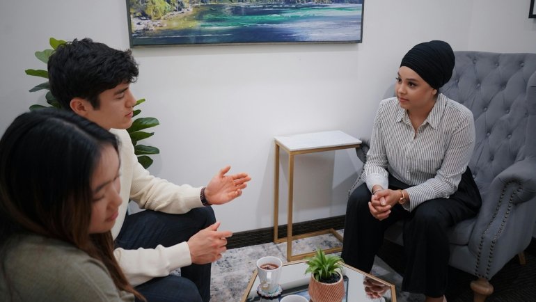 Traveler effectively communicating with customer service to resolve a common travel problem, illustrating best practices for calm and efficient problem-solving in an airport or hotel setting.