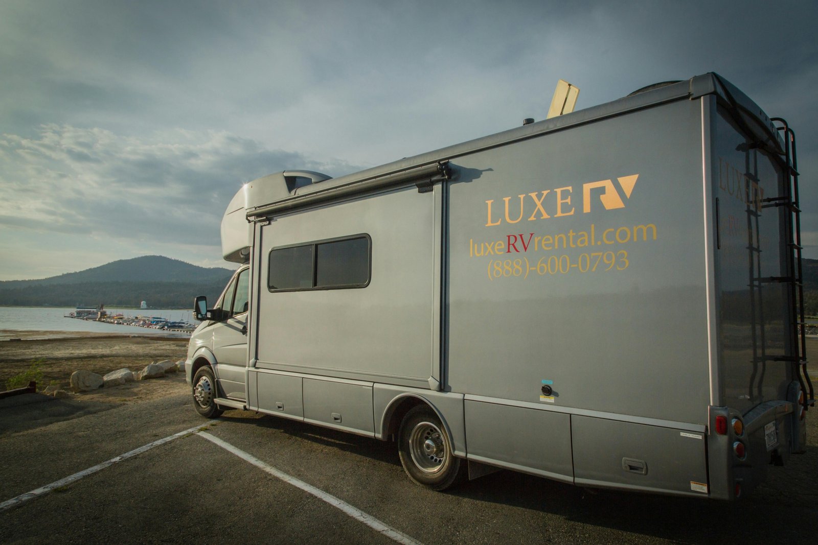 Lance travel trailer parked in a scenic natural environment, highlighting quality, comfort, and four-season camping for adventurous travelers.