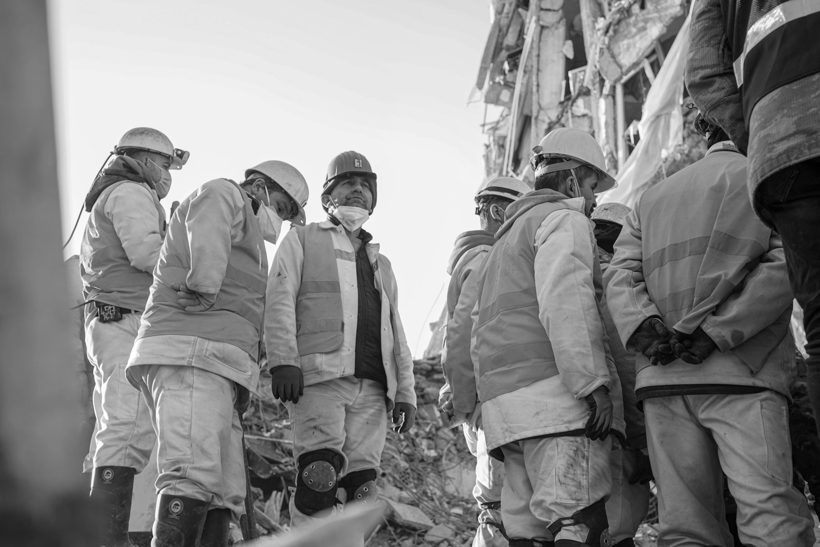 Diverse humanitarian aid workers providing emergency relief and support in a global disaster zone, representing traveling disaster relief jobs and community assistance.