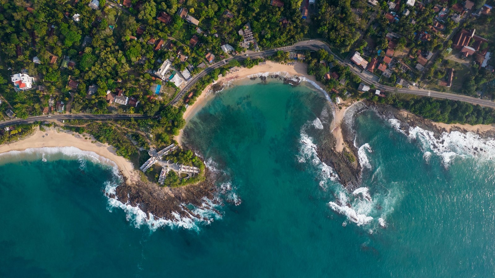 Stunning panoramic view of Sri Lanka featuring sun-kissed beaches, verdant tea plantations, and an ancient temple, symbolizing the island's ideal travel times and diverse regional attractions.