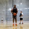 Competitive youth travel basketball team practice with young players developing skills and teamwork, preparing for AAU club tryouts and tournaments.