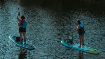 The WanderFit Sisters, Alex and Chloe, inspiring healthy travel, fitness, and wellness while exploring a scenic destination.