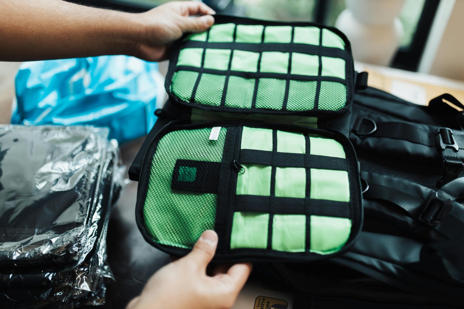 Person packing a suitcase efficiently with various compression packing cubes, demonstrating space-saving and organized travel luggage.