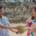 Vibrant Jamaican beach scene with turquoise waters, lush green palms, and happy travelers, embodying the island's rich culture and perfect tropical travel destination.