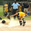 Competitive youth fastpitch softball team in action during a tournament, highlighting skilled young female players, teamwork, and passion for travel softball. Perfect for guides on finding teams and preparing for tryouts.