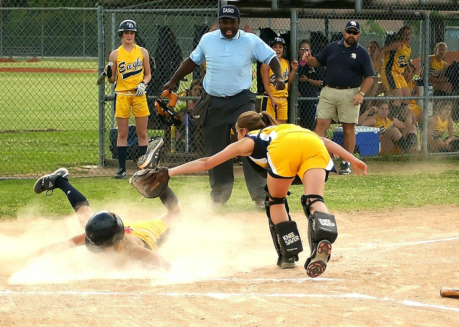 Competitive youth fastpitch softball team in action during a tournament, highlighting skilled young female players, teamwork, and passion for travel softball. Perfect for guides on finding teams and preparing for tryouts.