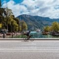Travelers Rest, SC: People enjoying the vibrant small town main street and cycling on the Swamp Rabbit Trail, framed by the picturesque Blue Ridge Mountains, showcasing the ideal lifestyle for homes for sale.