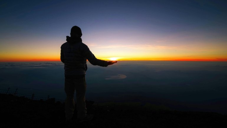 Peaceful traveler in a serene landscape, symbolizing spiritual protection and guidance for safe and mindful journeys and a grateful return.
