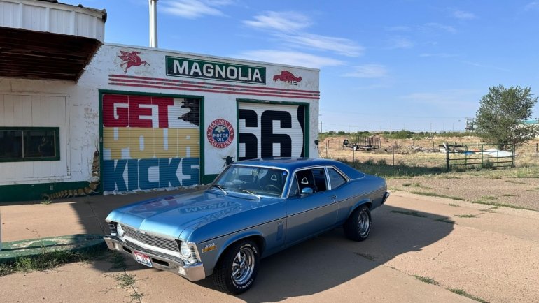 Sky City Travel Center in New Mexico desert, featuring gas pumps and a well-lit convenience store, serving as a vital rest stop for I-40 road trip travelers near Acoma.