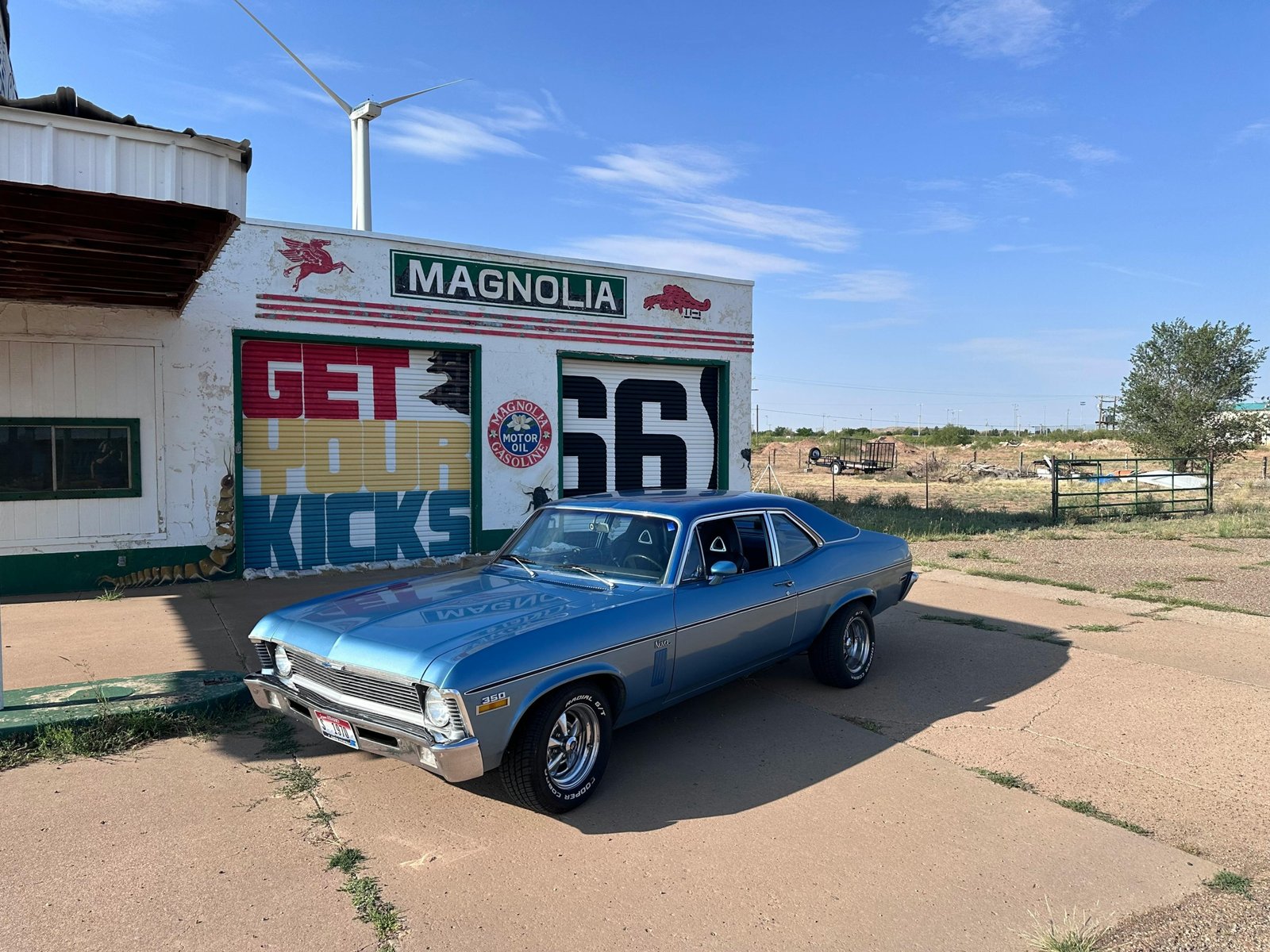Sky City Travel Center in New Mexico desert, featuring gas pumps and a well-lit convenience store, serving as a vital rest stop for I-40 road trip travelers near Acoma.