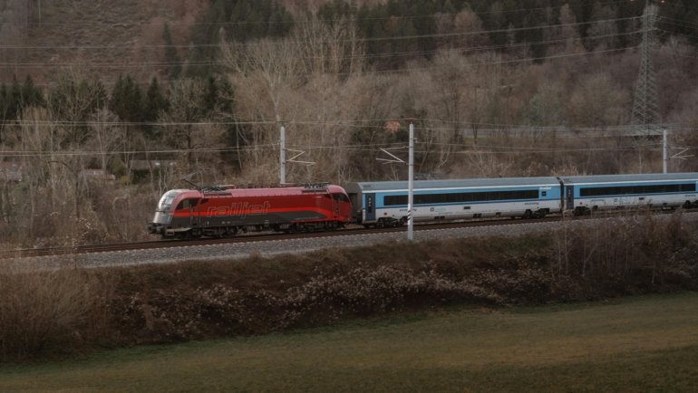 A modern high-speed train traveling through the beautiful European countryside, symbolizing the comfortable and scenic rail journey from Zurich to Paris.