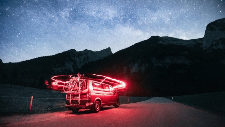 Mercedes Sprinter travel van conversion parked on a scenic road, illustrating the comfort and freedom of van life adventure.