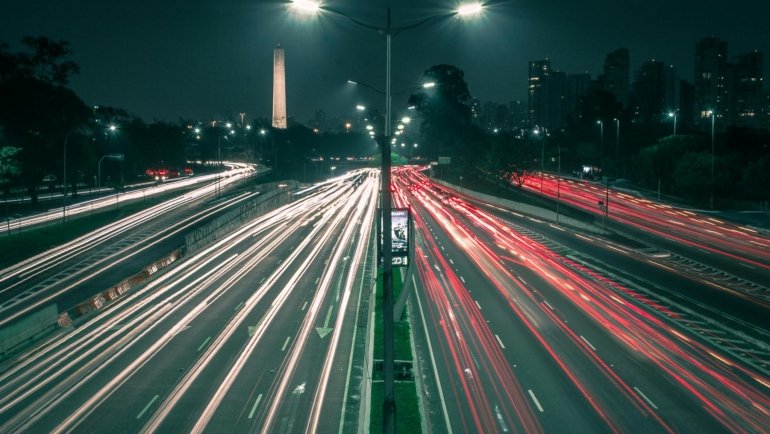 Modern Oasis Travel Center at night, a comprehensive roadside haven providing fuel, food, clean restrooms, and amenities for professional drivers and families.
