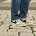 Comfortable and stylish walking shoes on a traveler's feet, navigating a classic European cobblestone street for extended sightseeing in historic cities.