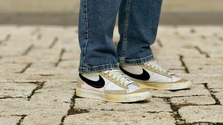 Comfortable and stylish walking shoes on a traveler's feet, navigating a classic European cobblestone street for extended sightseeing in historic cities.