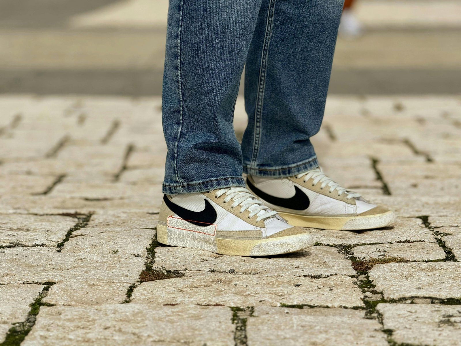 Comfortable and stylish walking shoes on a traveler's feet, navigating a classic European cobblestone street for extended sightseeing in historic cities.