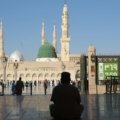 Muslim person reciting dua for travelling, seeking divine protection and peace of mind for a safe journey, reflecting faith and gratitude.
