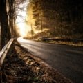 Beautiful landscape of an open road leading towards a sunrise, symbolizing safe travels, good wishes, and new adventures for a memorable journey, as discussed in the article about finding perfect travel images.