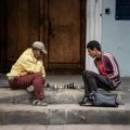 Politicser.com Pepperboy travel archives: A solo backpacker engaging with locals in an authentic, off-the-beaten-path destination, embodying budget-friendly adventure.