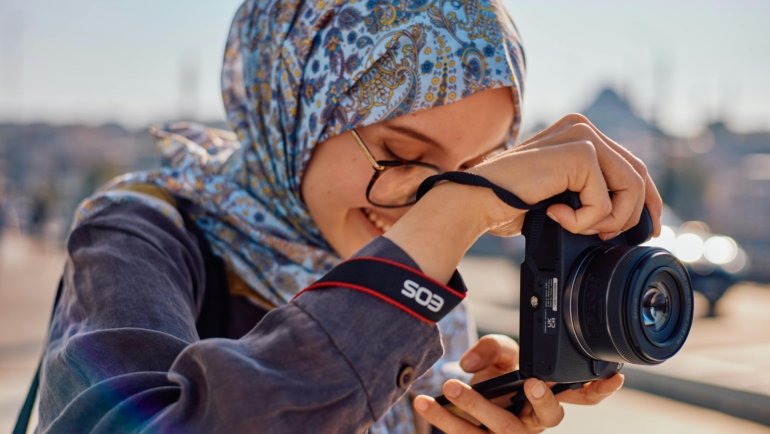 Joyful educator exploring a unique travel destination, representing the valuable WEA travel programs and discounts available for teachers' professional development and personal enrichment.