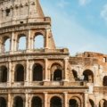 Happy travelers exploring an iconic Roman landmark, illustrating the joy and convenience of Rome travel packages for a dream Italian vacation.