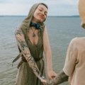 Couple embracing freedom and nature on a clothing-optional beach, symbolizing body positivity, self-acceptance, and the liberating philosophy of naturist travel.