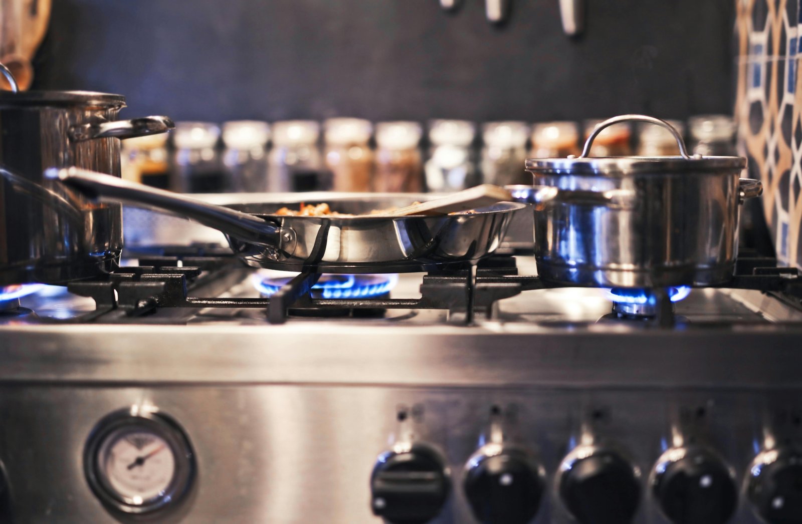 Modern propane stove in a cozy travel trailer kitchen, actively used for cooking a delicious meal, highlighting the convenience and off-grid capability for RV and camping adventures.