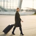 Longchamp travel suitcase at an airport, symbolizing luxury, durability, and timeless elegance for discerning travelers. Features premium design and smooth-rolling wheels.
