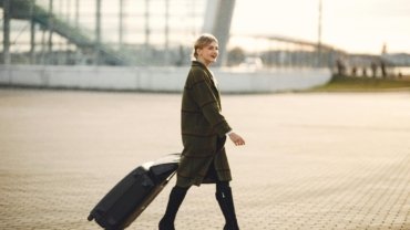 Longchamp travel suitcase at an airport, symbolizing luxury, durability, and timeless elegance for discerning travelers. Features premium design and smooth-rolling wheels.