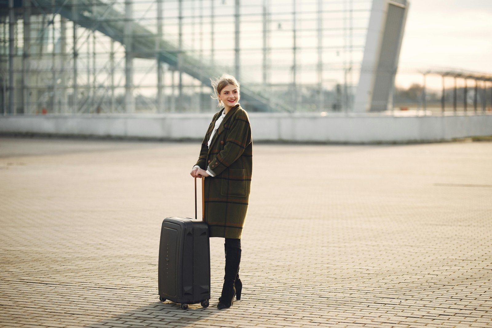 Stylish person with a luxury Gucci-style travel bag in an elegant airport terminal, showcasing high-end travel and iconic design.