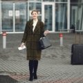 Stylish Steve Madden travel bag set (carry-on and checked bag) with spinner wheels, being effortlessly pulled by a fashion-forward traveler in a modern airport terminal.