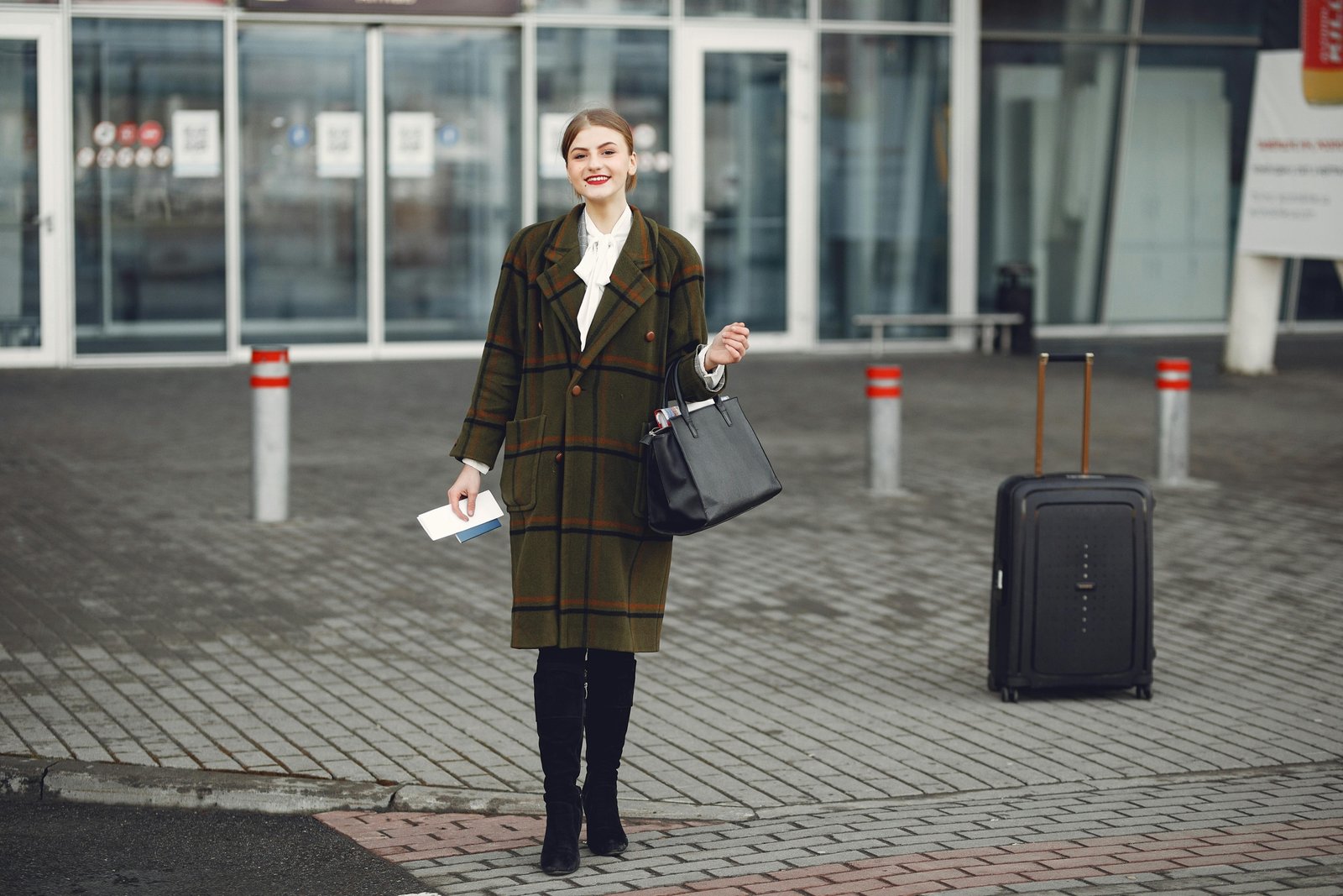 Stylish Steve Madden travel bag set (carry-on and checked bag) with spinner wheels, being effortlessly pulled by a fashion-forward traveler in a modern airport terminal.
