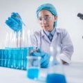 Traveling pharmacy technician professional in a modern healthcare setting, smiling confidently, with a subtle background hinting at travel and diverse locations. This image represents a dynamic and flexible career in healthcare.