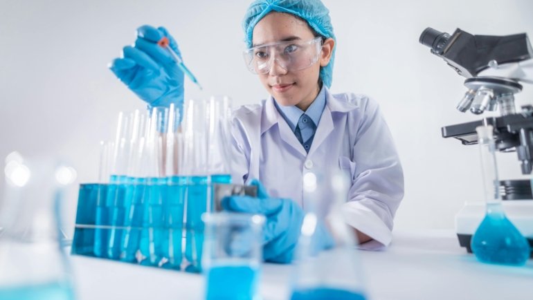 Traveling pharmacy technician professional in a modern healthcare setting, smiling confidently, with a subtle background hinting at travel and diverse locations. This image represents a dynamic and flexible career in healthcare.