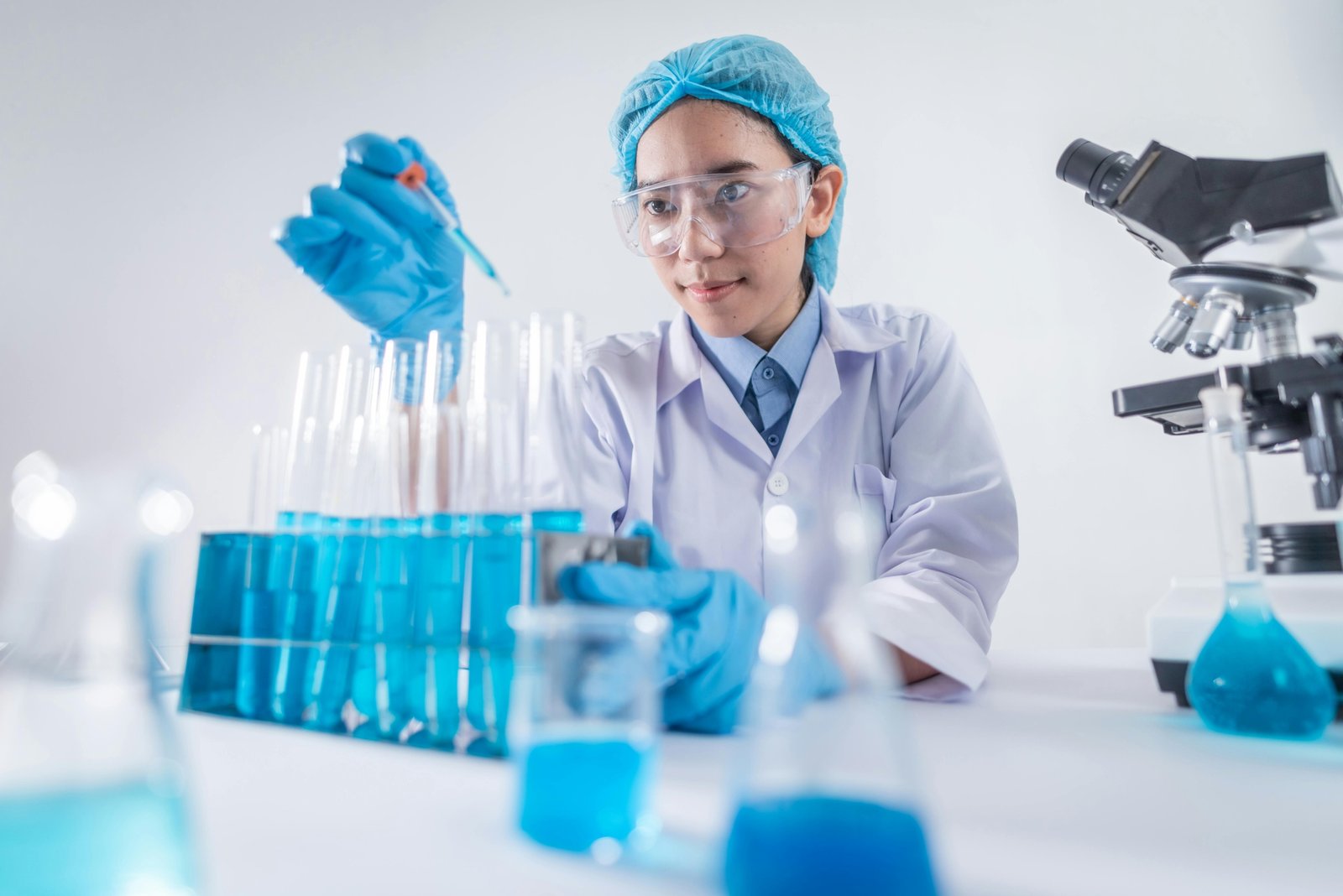 Traveling pharmacy technician professional in a modern healthcare setting, smiling confidently, with a subtle background hinting at travel and diverse locations. This image represents a dynamic and flexible career in healthcare.