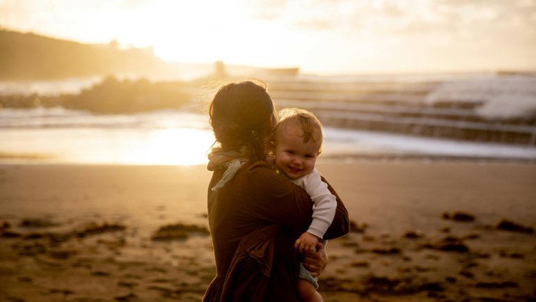 Parent using a portable travel changing pad to change a baby's diaper outdoors, emphasizing convenience and hygiene for families on the go.