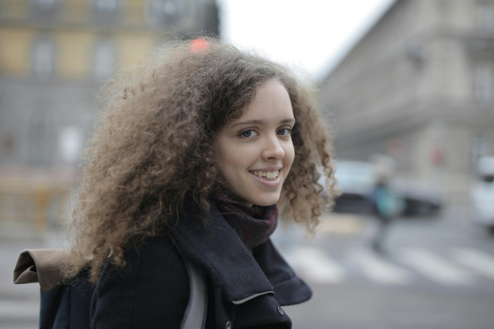 Stylish woman exploring a European city with a secure anti-theft crossbody bag, showcasing hands-free travel convenience and peace of mind.