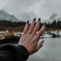 Hand wearing a stylish travel ring (an affordable alternative to an engagement or wedding ring) while on a beautiful vacation, illustrating worry-free travel and protection of precious jewelry.