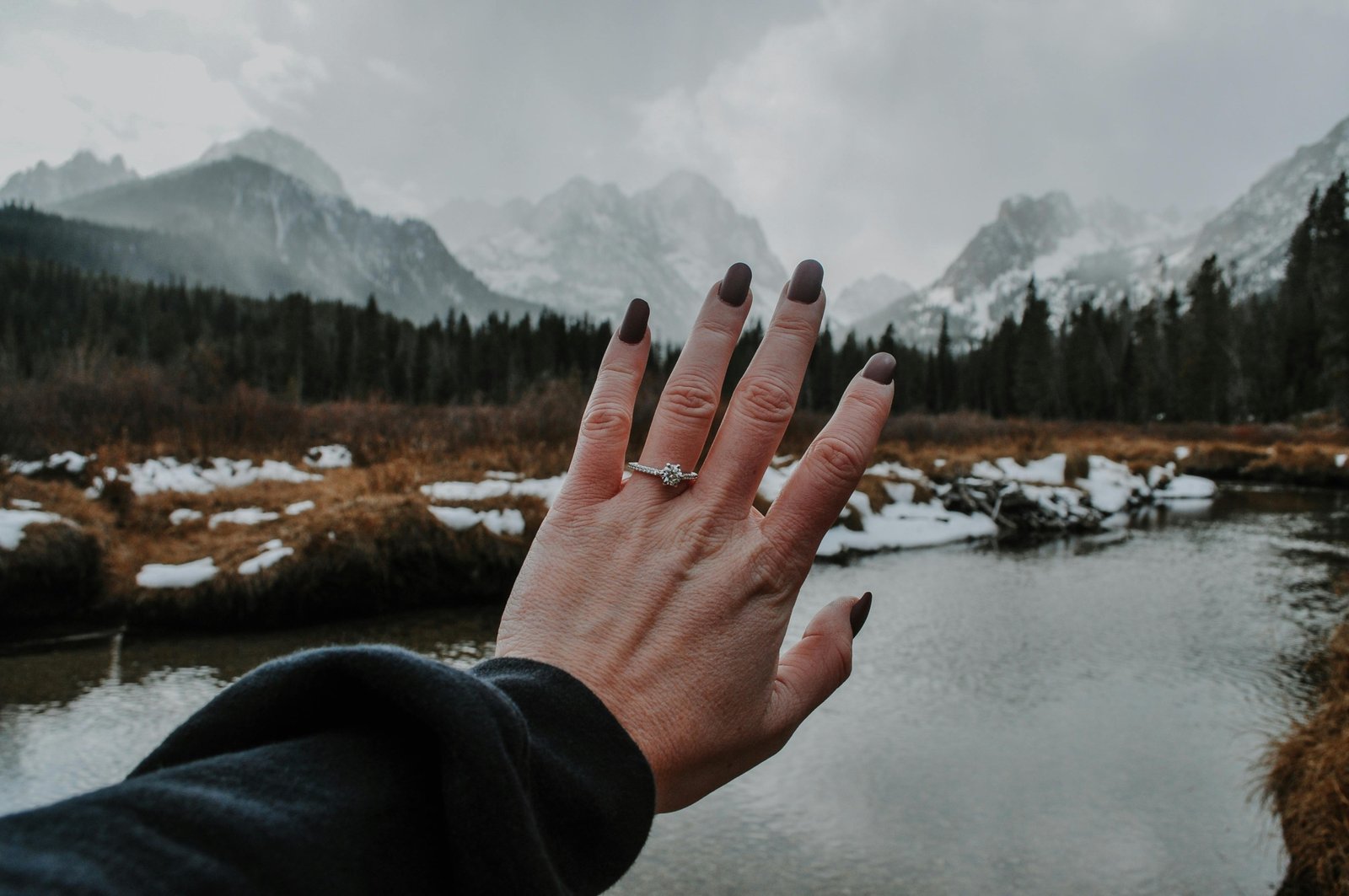 Hand wearing a stylish travel ring (an affordable alternative to an engagement or wedding ring) while on a beautiful vacation, illustrating worry-free travel and protection of precious jewelry.