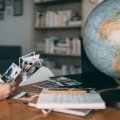 An inspiring image of someone planning their bucket list travel destinations on a world map, envisioning unforgettable global adventures and cultural experiences.